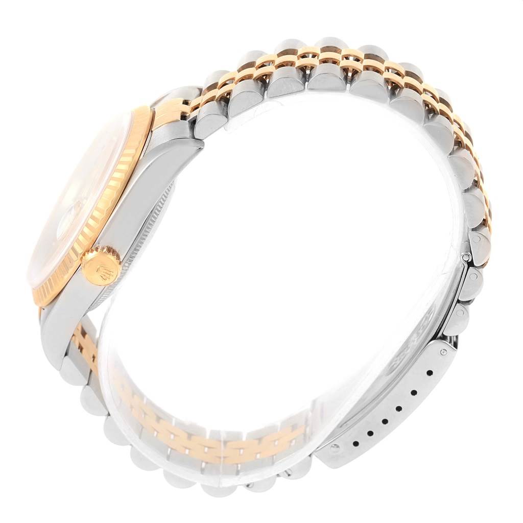 The image shows a side view of a Rolex Datejust 16233 Steel and Gold (two tone) Champagne Dial 16233 Steel and Gold (two tone) Champagne Dial watch, highlighting its crown, case, and two-tone metal bracelet.