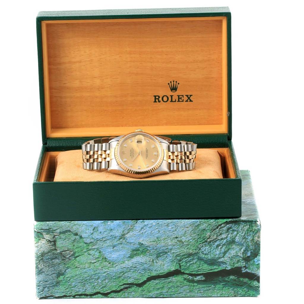 The Rolex Datejust 16233 Steel and Gold (two tone) Champagne Dial 16233 Steel and Gold (two tone) Champagne Dial watch is shown front-facing inside an open green and wood Rolex box.