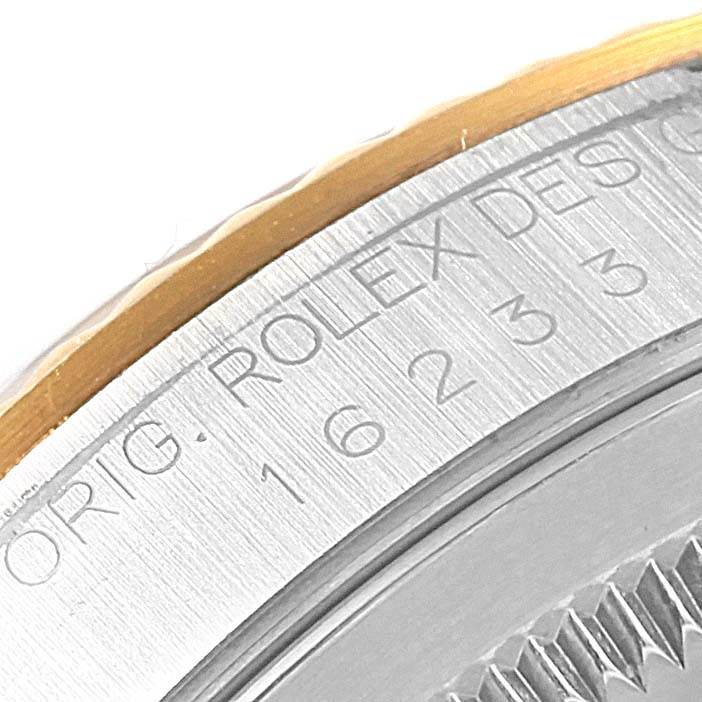 The image shows a close-up of the bezel and the edge of the dial of a Rolex Datejust 16233 Men's Steel and Gold (two tone) Beige Dial 16233 Men's Steel and Gold (two tone) Beige Dial watch, highlighting the "ROLEX" engraving.