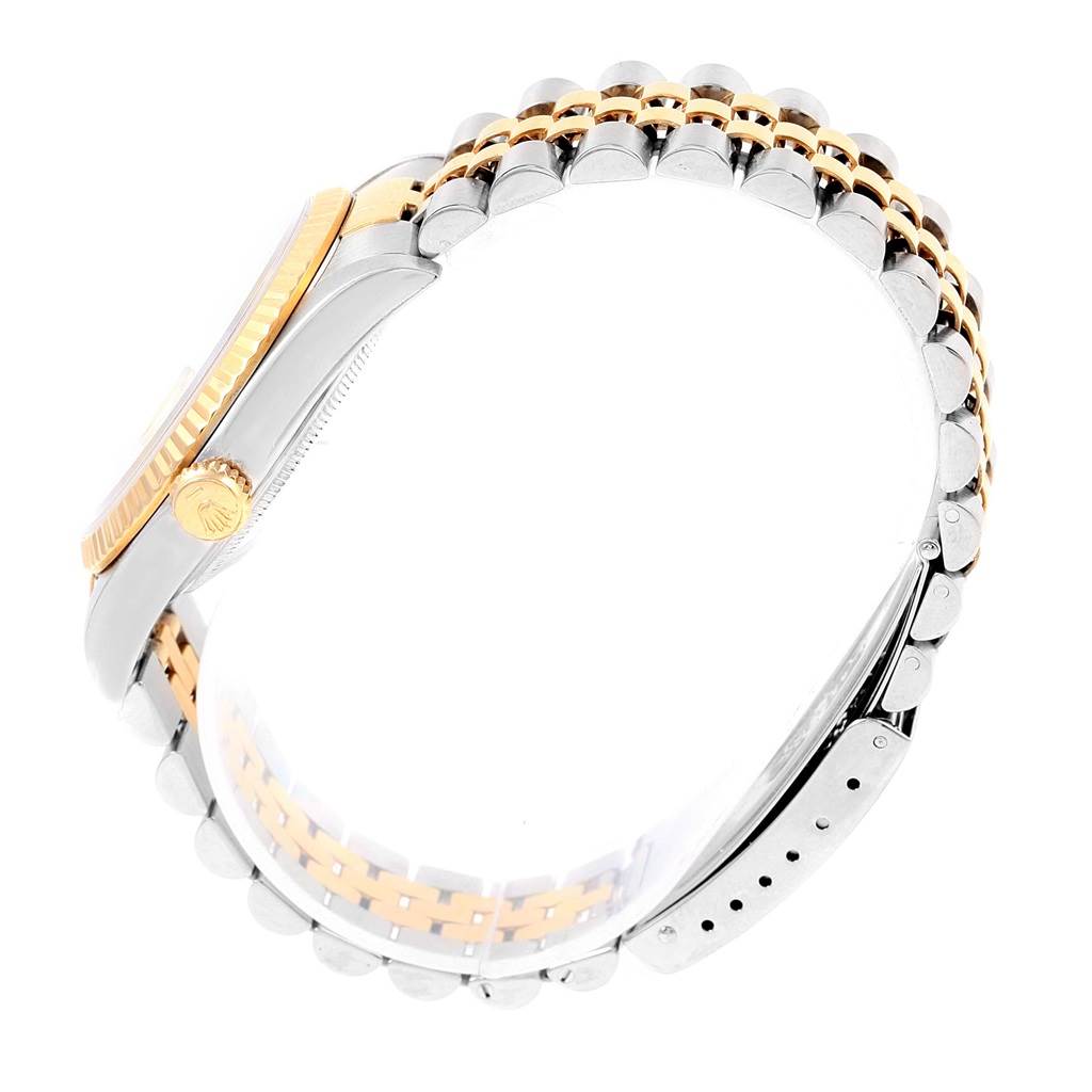 The image shows a side view of a Rolex Datejust 16233 Men's Steel and Gold (two tone) Beige Dial 16233 Men's Steel and Gold (two tone) Beige Dial watch highlighting its two-tone bracelet and fluted bezel.