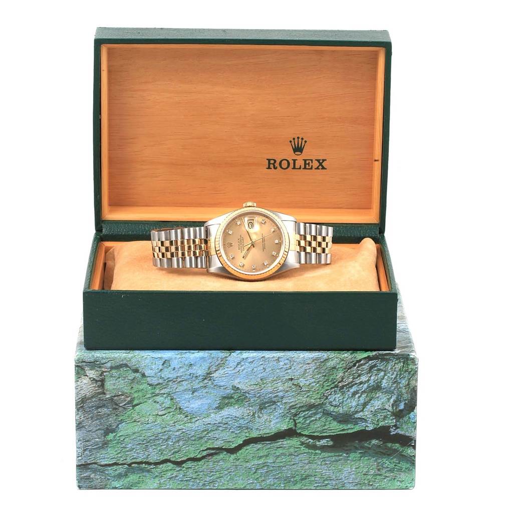 This image shows a frontal view of a Rolex Datejust 16233 Steel and Gold (two tone) Champagne Dial 16233 Steel and Gold (two tone) Champagne Dial watch displayed in its open green and wooden box.