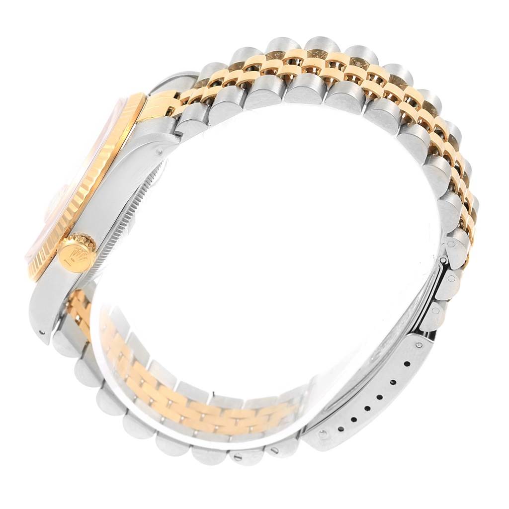 This side-view image of a Rolex Datejust 16233 Steel and Gold (two tone) Champagne Dial 16233 Steel and Gold (two tone) Champagne Dial watch shows the crown, bezel, and two-tone bracelet.