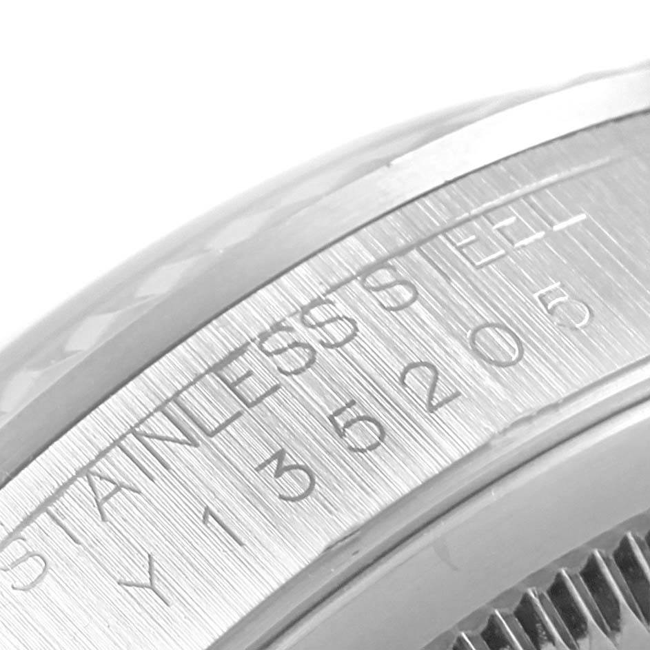 This image shows an up-close view of the side engravings on a stainless steel bezel of a Rolex Datejust 16234 Men's Stainless Steel Black Dial 16234 Men's Stainless Steel Black Dial watch.
