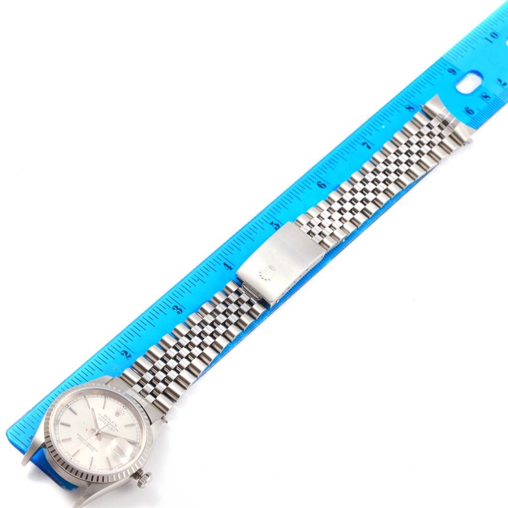 This image shows a Rolex Datejust 16220 Men's Stainless Steel Silver Dial 16220 Men's Stainless Steel Silver Dial watch, focusing on the face, dial, and entire bracelet, measured against a blue ruler.