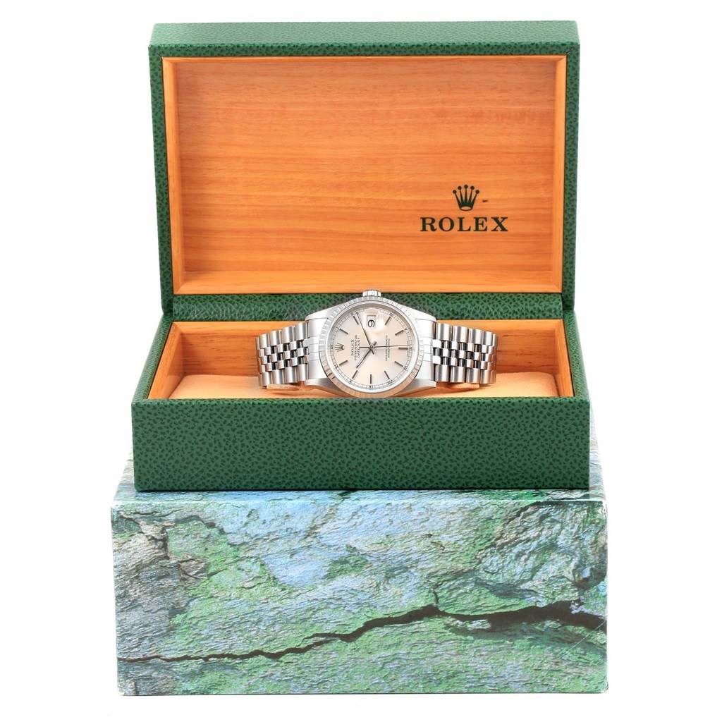 The Rolex Datejust 16220 Men's Stainless Steel Silver Dial 16220 Men's Stainless Steel Silver Dial watch is shown from a front angle, displayed in an open green and wood-grain box.
