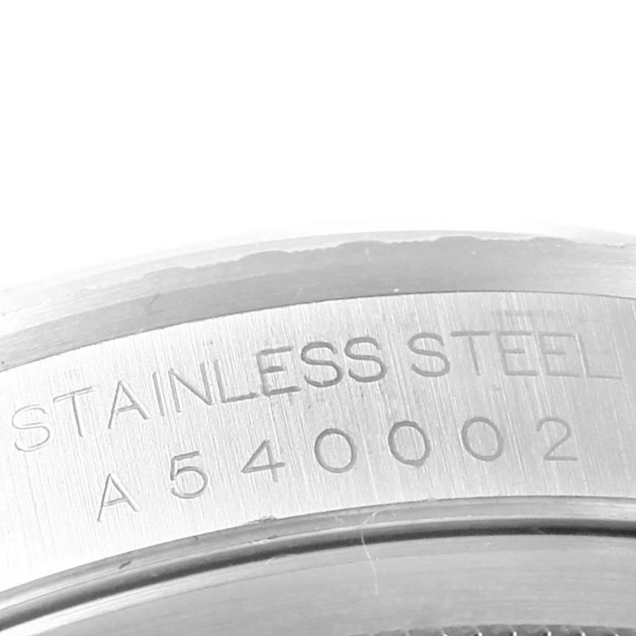 This image shows an engraved part of the stainless steel case back from a Rolex Datejust 16220 Men's Stainless Steel Silver Dial 16220 Men's Stainless Steel Silver Dial watch, captured at a close-up angle.