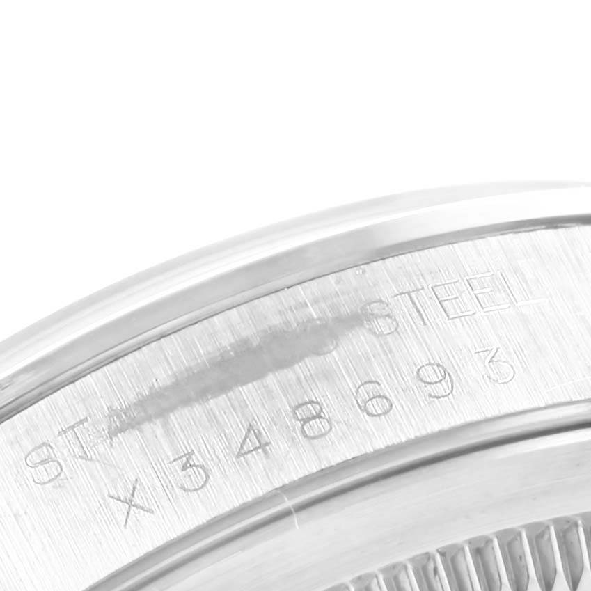 This image shows a close-up of the engraved serial number and "STAINLESS STEEL" text on the side of a Rolex Datejust 16220 Men's Stainless Steel Silver Dial 16220 Men's Stainless Steel Silver Dial watch.