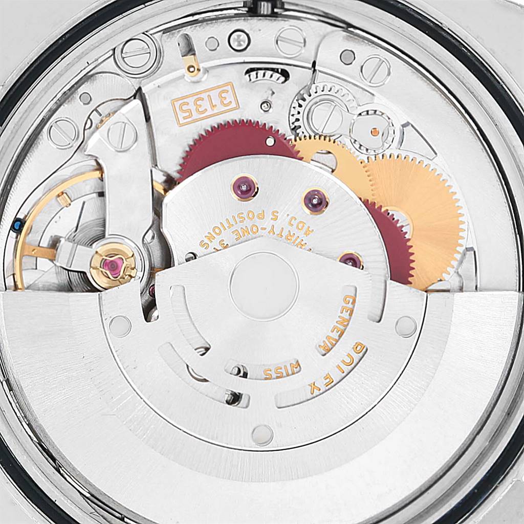 The image shows the intricate internal mechanism of a Rolex Datejust 116201 Men
s Steel and Gold (two tone) Black Dial 116201 Men
s Steel and Gold (two tone) Black Dial watch from a top-down angle, highlighting gears and components.