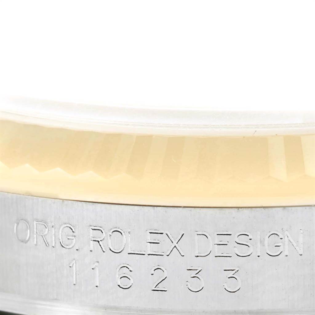 The image shows a close-up of the side of the Rolex Datejust 116233 Stainless Steel Beige Dial 116233 Stainless Steel Beige Dial model, highlighting the bezel and engraved serial numbers.