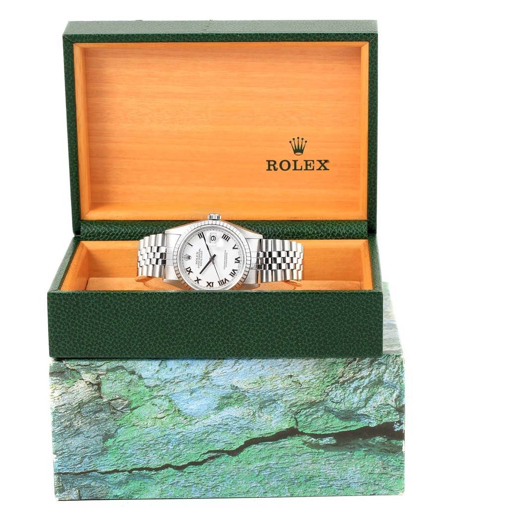 The Rolex Datejust 16220 Men's Stainless Steel White Dial 16220 Men's Stainless Steel White Dial watch is displayed frontally in an open green and wooden Rolex box.