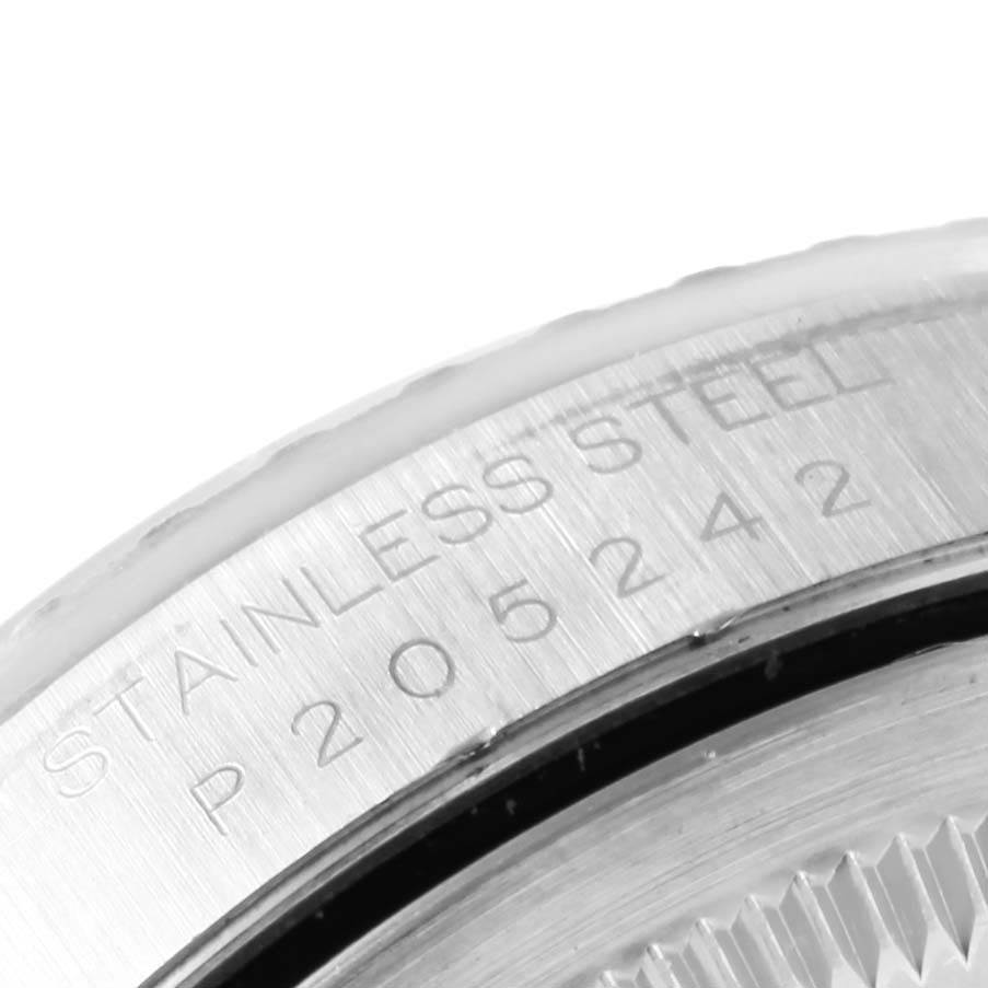 This close-up image shows the stainless steel bezel edge with engravings of a Rolex Datejust 16220 Men's Stainless Steel White Dial 16220 Men's Stainless Steel White Dial watch.