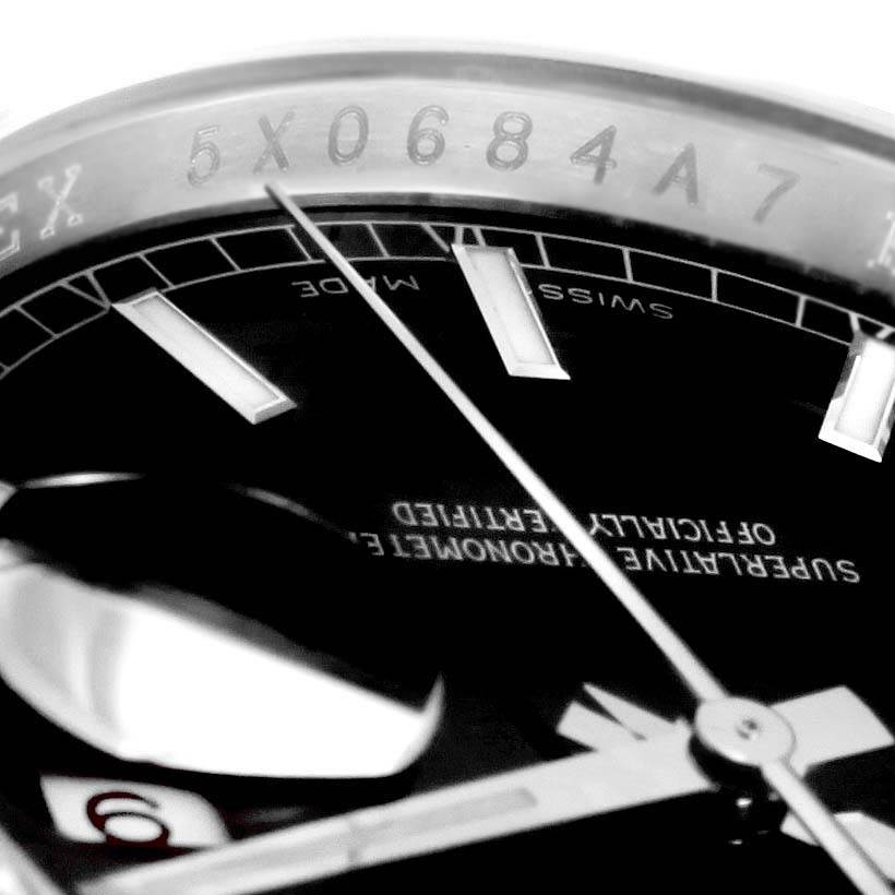 Close-up of a Rolex Datejust 116244 Stainless Steel Black Dial 116244 Stainless Steel Black Dial watch, showing part of the dial, hands, and serial number on the inner bezel.