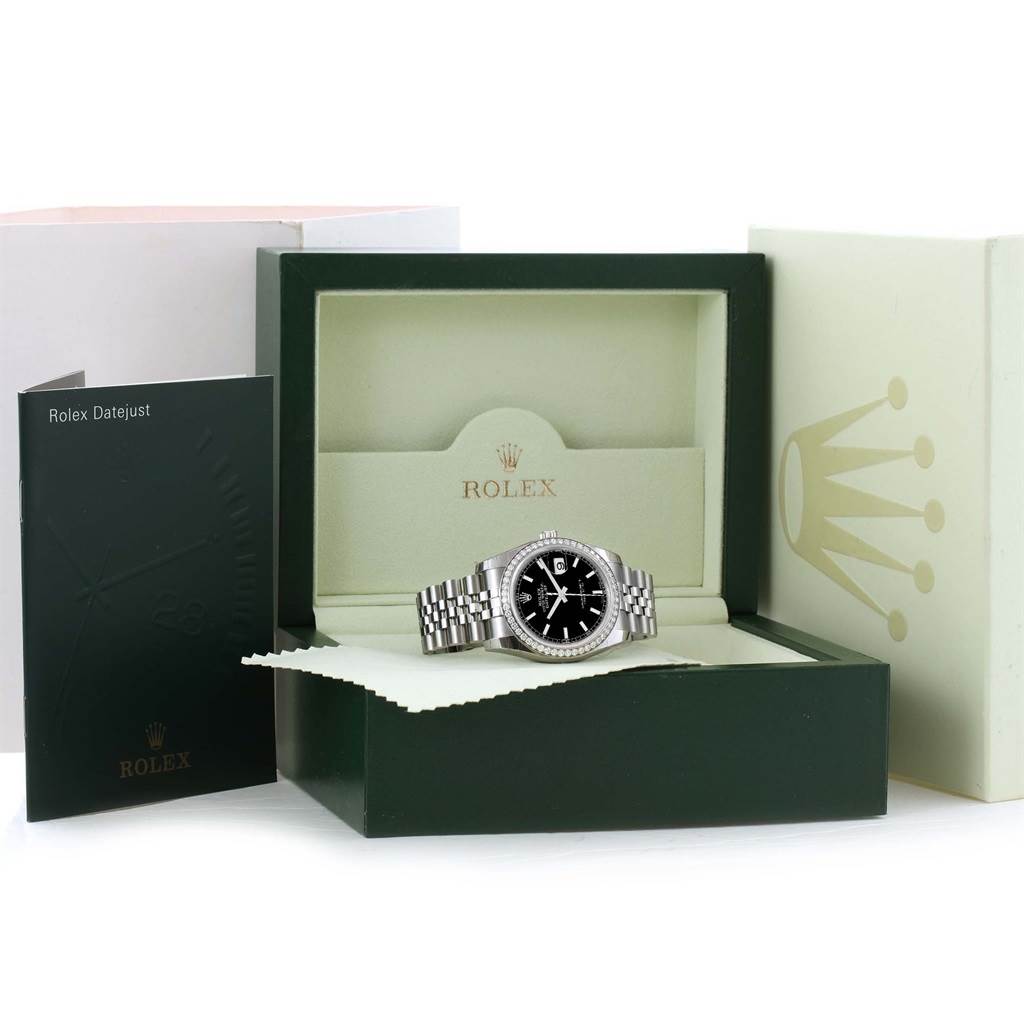 The Rolex Datejust 116244 Stainless Steel Black Dial 116244 Stainless Steel Black Dial watch is shown at a partial front angle, displayed in its open box with accompanying booklet and outer packaging.