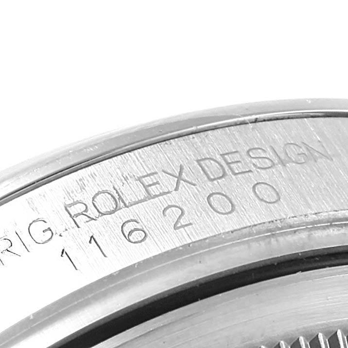 The image shows the engraved inner bezel part of the Rolex Datejust 116200 Men's Stainless Steel White Dial 116200 Men's Stainless Steel White Dial watch, displaying its model number.