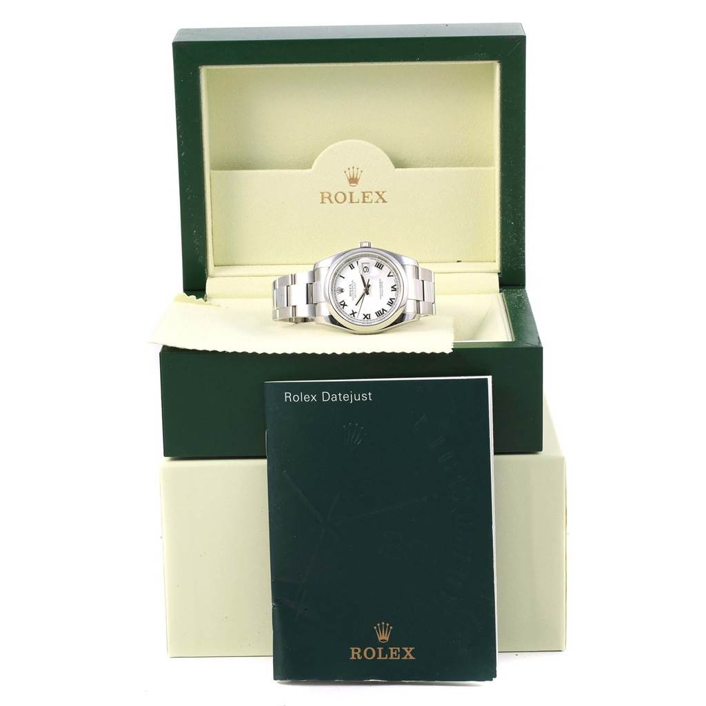 The Rolex Datejust 116200 Men's Stainless Steel White Dial 116200 Men's Stainless Steel White Dial watch is shown in its box along with the user's manual in an upright position.