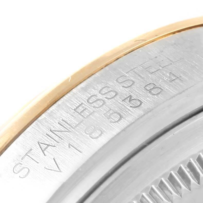 This is a close-up angle of the case back engraving and fluted bezel of the Rolex Datejust 116203 Stainless Steel Champagne Dial 116203 Stainless Steel Champagne Dial watch.