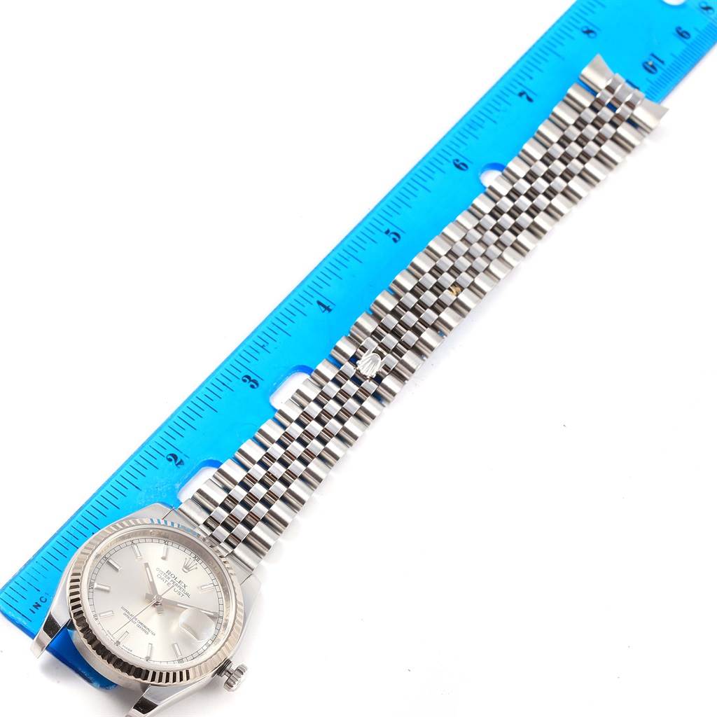 The image shows a Rolex Datejust 116234 Men's Stainless Steel Silver Dial 116234 Men's Stainless Steel Silver Dial watch laid flat, face up with a ruler measuring its bracelet length.