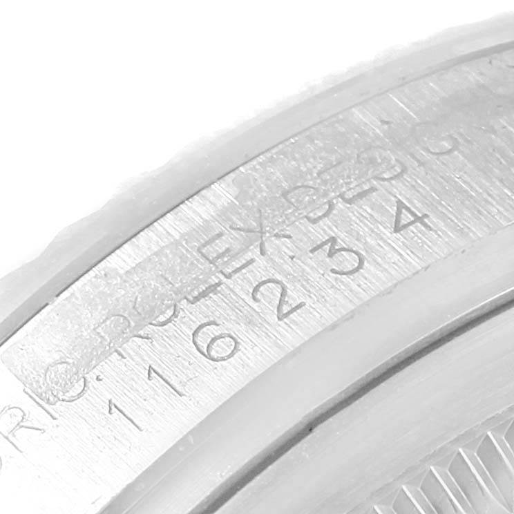 This image shows a close-up of the engraving on the inner bezel of a Rolex Datejust 116234 Men's Stainless Steel Silver Dial 116234 Men's Stainless Steel Silver Dial watch.