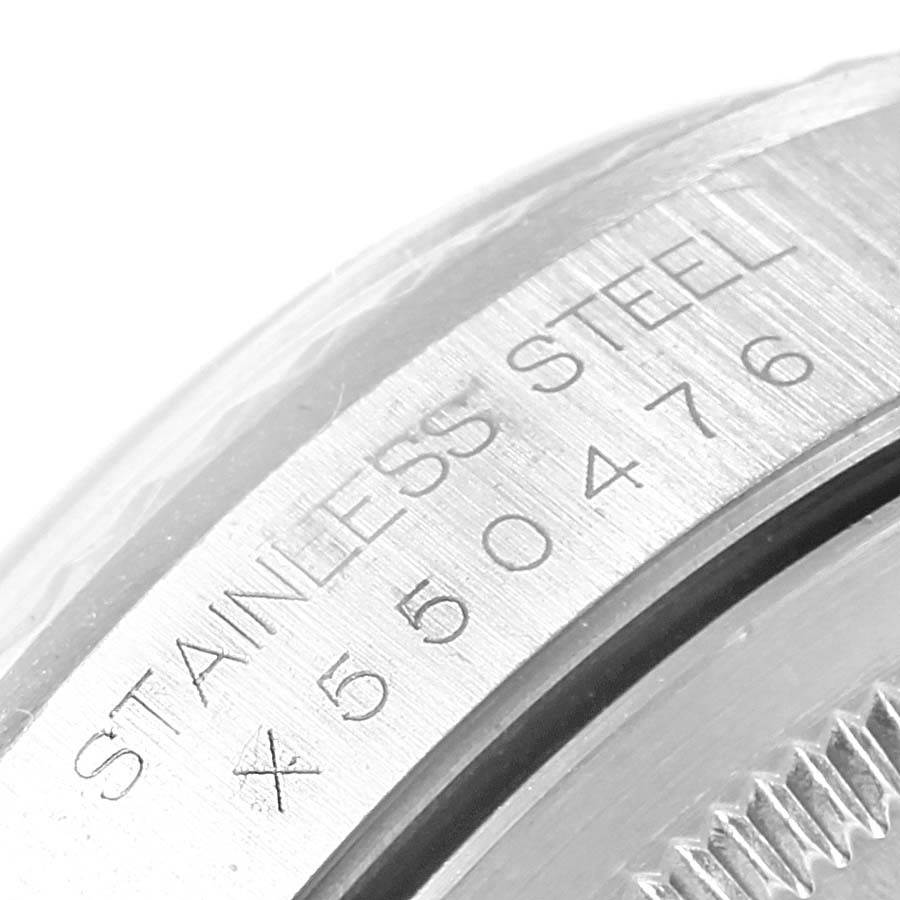 This image shows a close-up of the case back of a Rolex Datejust 16234 Men's Stainless Steel White Dial 16234 Men's Stainless Steel White Dial, highlighting the "Stainless Steel" text and serial number.
