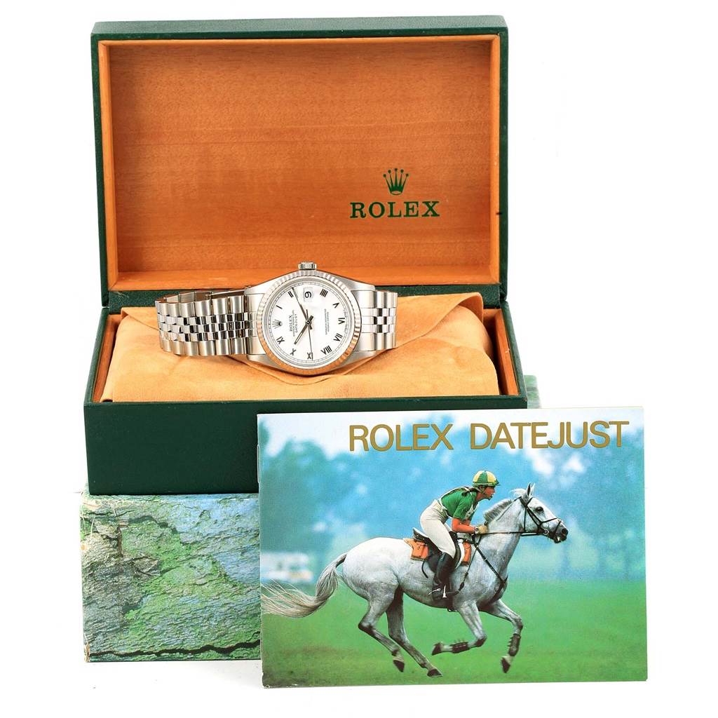 The Rolex Datejust 16234 Men's Stainless Steel White Dial 16234 Men's Stainless Steel White Dial watch is shown in its open green and orange box with a booklet placed in front.