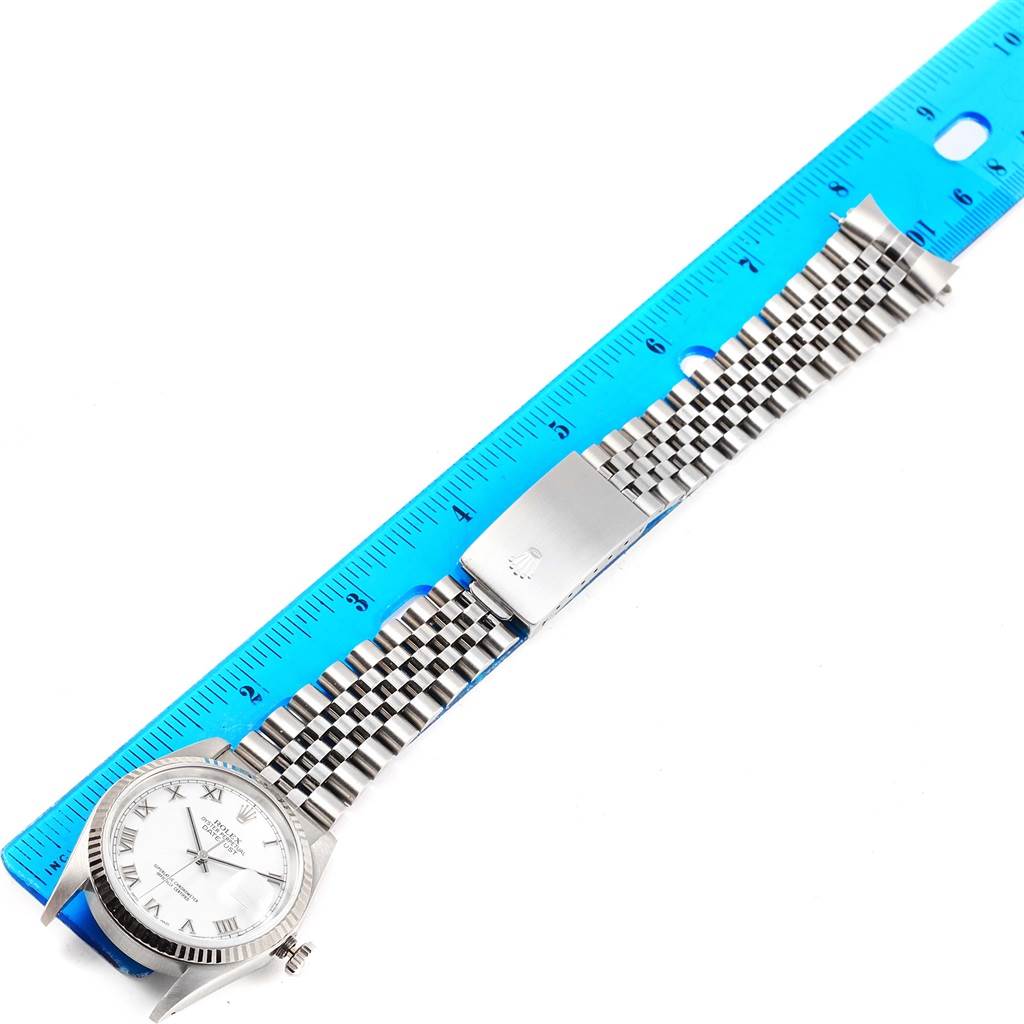 The image shows a Rolex Datejust 16234 Stainless Steel White Dial 16234 Stainless Steel White Dial watch laid flat against a ruler, displaying the dial, bezel, bracelet, and clasp.