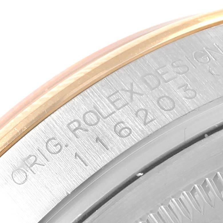 The image shows a close-up of the engraved serial and model number on the edge of a Rolex Datejust 116203 Stainless Steel Mother of Pearl Dial 116203 Stainless Steel Mother of Pearl Dial watch case.
