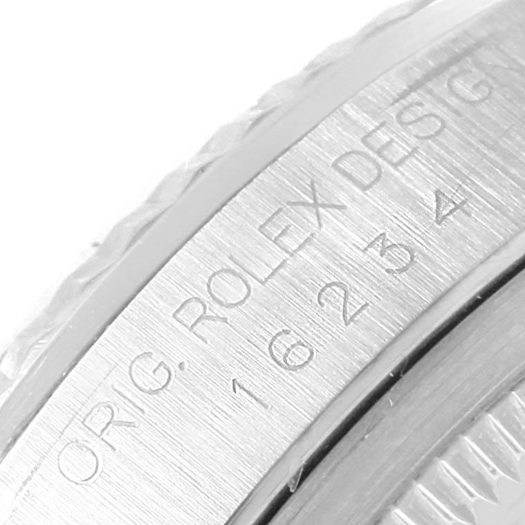 The image shows a close-up of the side view of the engraved bezel of a Rolex Datejust 16234 Men's Stainless Steel White Dial 16234 Men's Stainless Steel White Dial model.