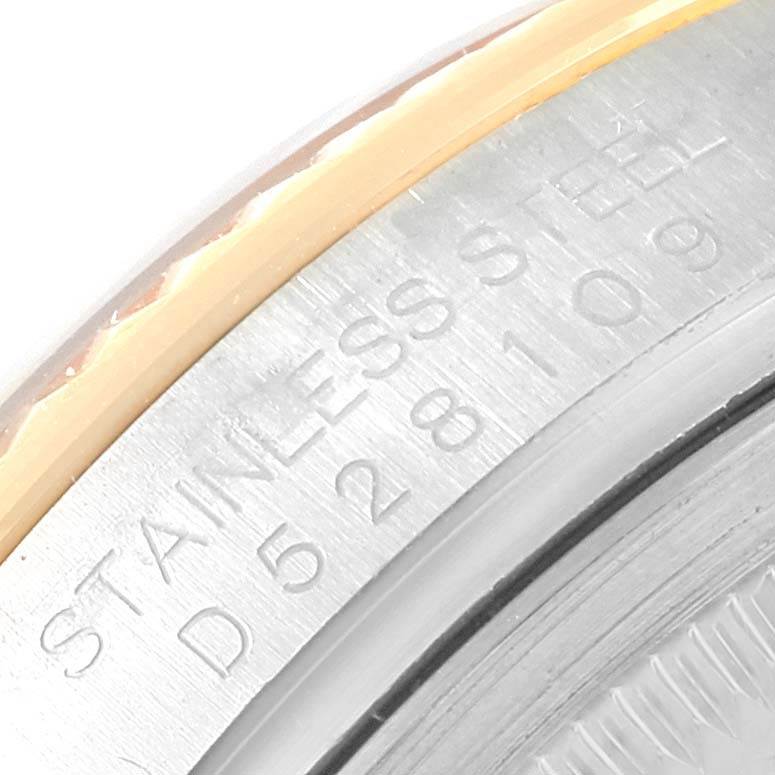 This image shows a close-up of the case back edge of a Rolex Datejust 116233 Stainless Steel Champagne Dial 116233 Stainless Steel Champagne Dial watch, highlighting its stainless steel material and engraved serial number.