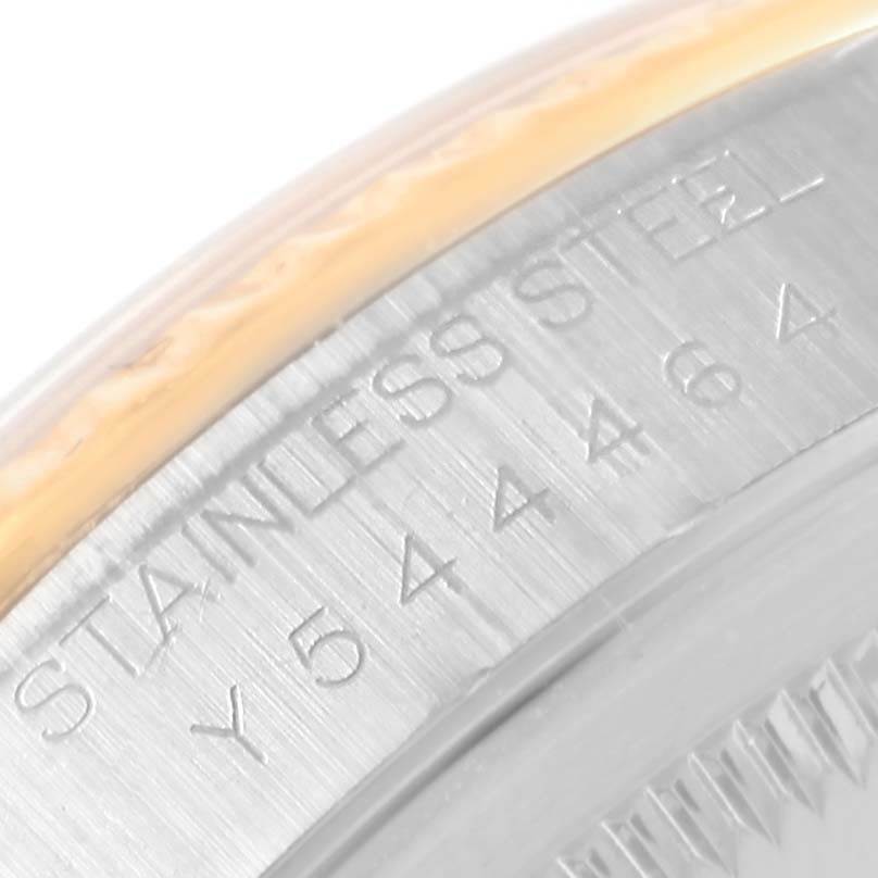 This image shows the edge of the casing with engraved text on a Rolex Datejust 16233 Men's Steel and Gold (two tone) Beige Dial 16233 Men's Steel and Gold (two tone) Beige Dial watch, highlighting the stainless steel material and serial number.