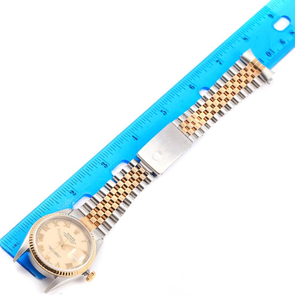 The image shows a Rolex Datejust 16233 Men's Steel and Gold (two tone) Beige Dial 16233 Men's Steel and Gold (two tone) Beige Dial watch from a top-down angle, highlighting the face, bezel, and two-tone bracelet beside a blue ruler.