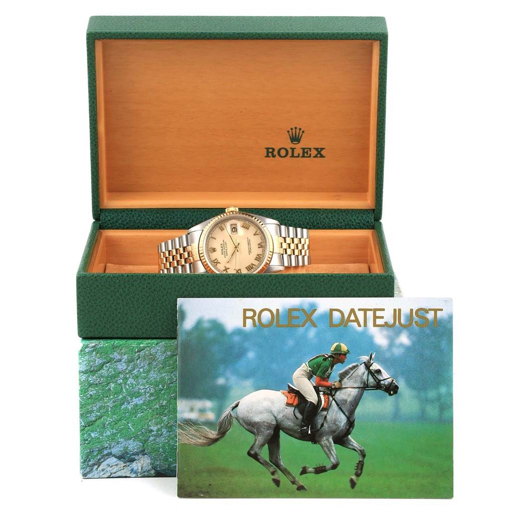 This image shows a Rolex Datejust 16233 Men's Steel and Gold (two tone) Beige Dial 16233 Men's Steel and Gold (two tone) Beige Dial watch at a semi-frontal angle, displayed inside an open Rolex box with its brochure.