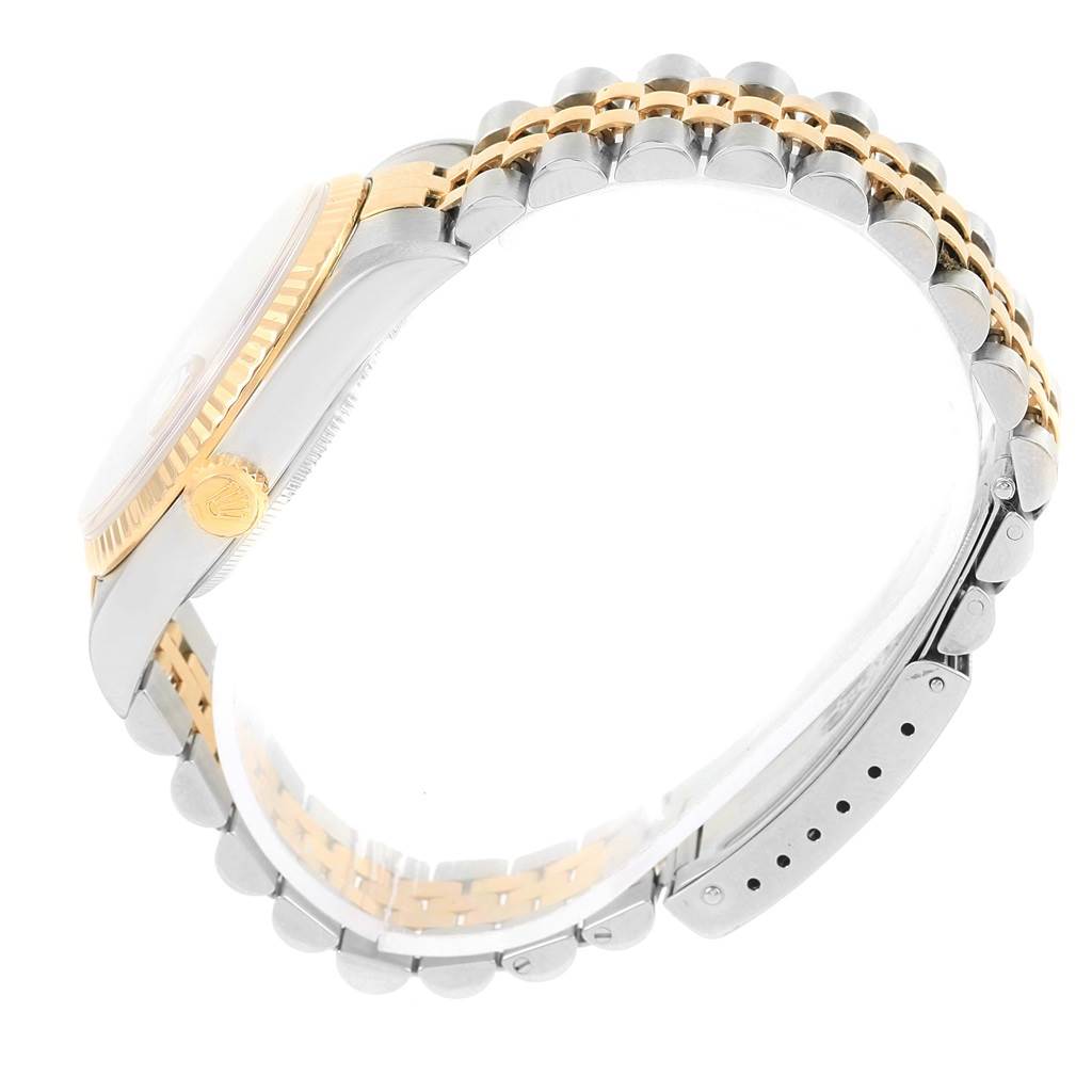 The image shows a side view of a Rolex Datejust 16233 Men's Steel and Gold (two tone) Beige Dial 16233 Men's Steel and Gold (two tone) Beige Dial watch, highlighting its two-tone bracelet and fluted bezel.