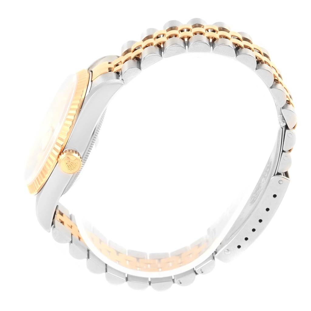 The image shows a side view of a Rolex Datejust 16233 Steel and Gold (two tone) Champagne Dial 16233 Steel and Gold (two tone) Champagne Dial watch, highlighting its crown, bezel, and integrated two-tone bracelet.