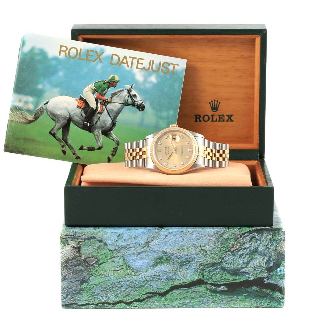 The Rolex Datejust 16233 Steel and Gold (two tone) Champagne Dial 16233 Steel and Gold (two tone) Champagne Dial watch is shown from the front inside its open box, alongside an instruction booklet.