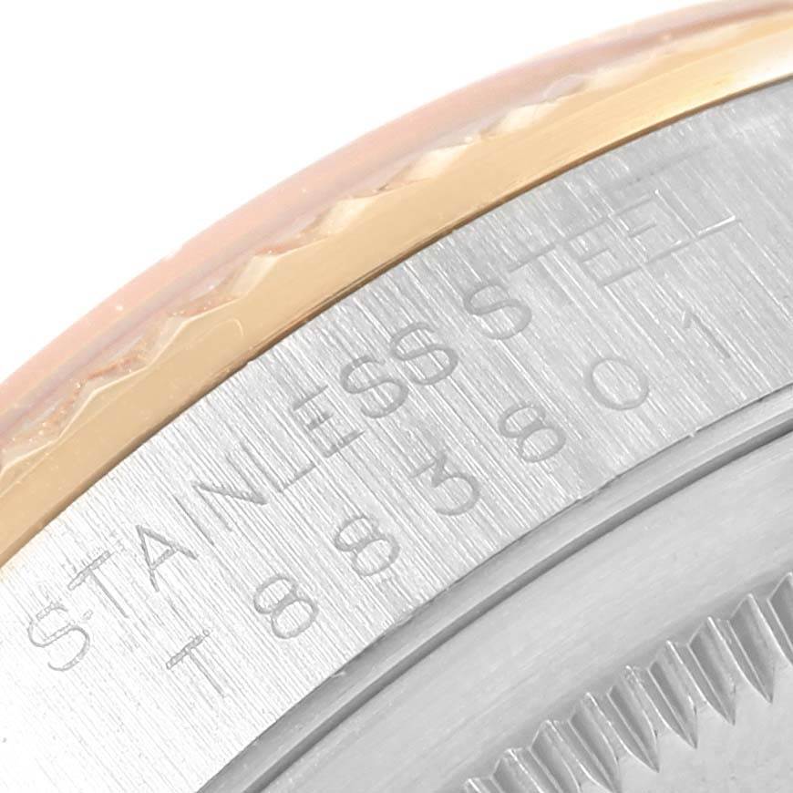The image shows a close-up of the bezel and the edge of the caseback of a Rolex Datejust 16233 Steel and Gold (two tone) Champagne Dial 16233 Steel and Gold (two tone) Champagne Dial, featuring stainless steel and a fluted bezel.