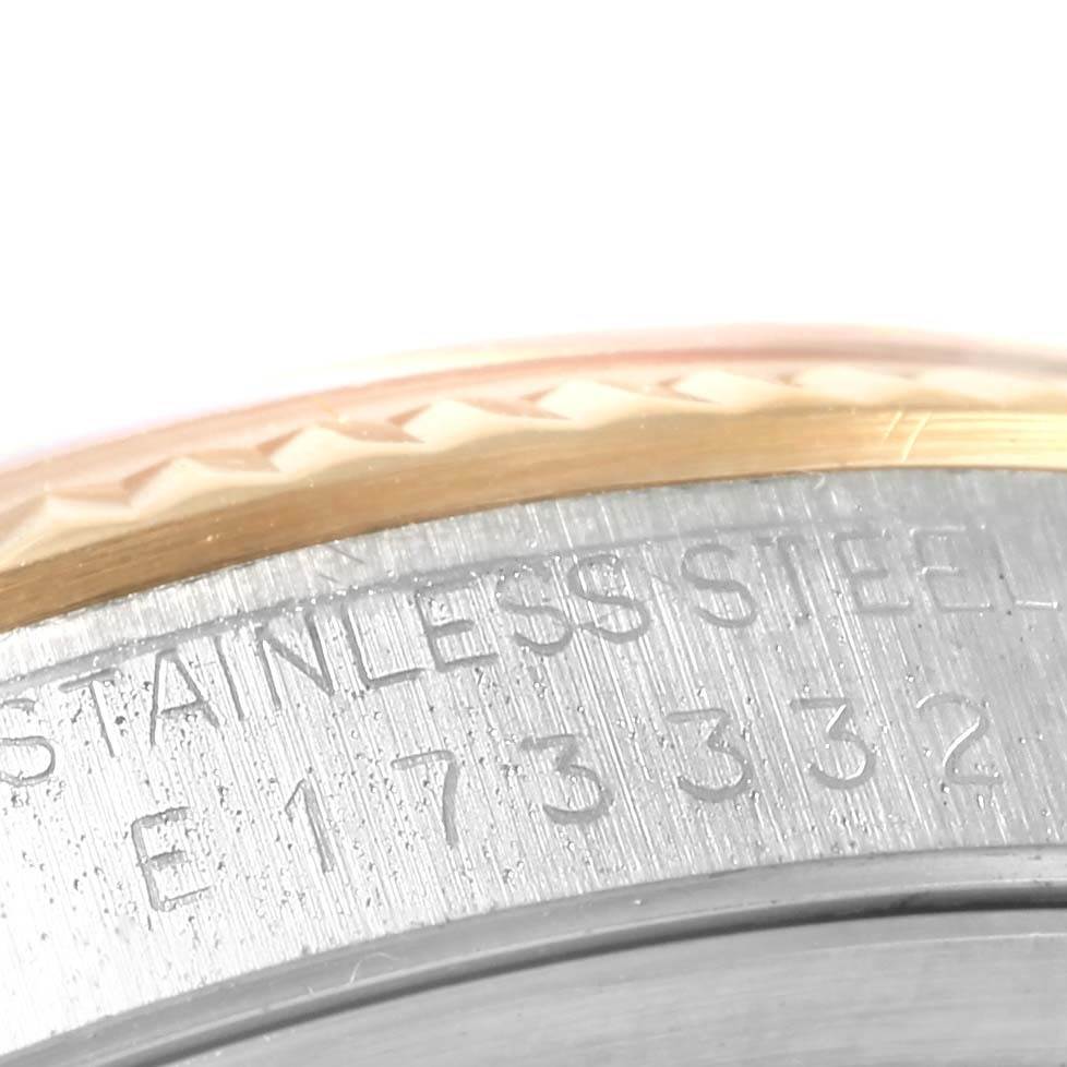 This close-up image shows the engraved serial number on the stainless steel bezel of the Rolex Datejust 16233 Men's Steel and Gold (two tone) Silver Dial 16233 Men's Steel and Gold (two tone) Silver Dial watch.