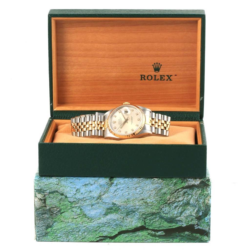 The Rolex Datejust 16233 Men's Steel and Gold (two tone) Silver Dial 16233 Men's Steel and Gold (two tone) Silver Dial watch is displayed from a front angle inside its green and wooden Rolex box.