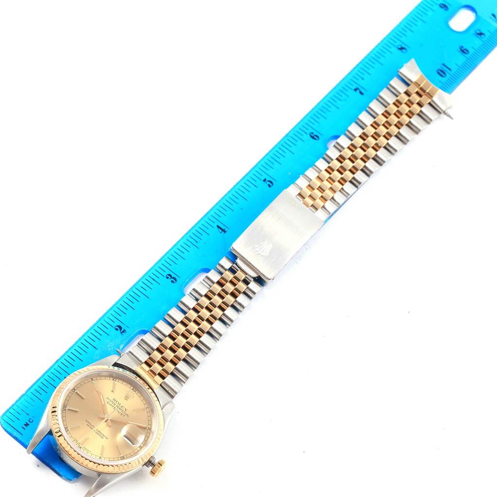 The Rolex Datejust 16233 Steel and Gold (two tone) Champagne Dial 16233 Steel and Gold (two tone) Champagne Dial watch is displayed with a full view of the face, band, and clasp, alongside a measuring ruler.