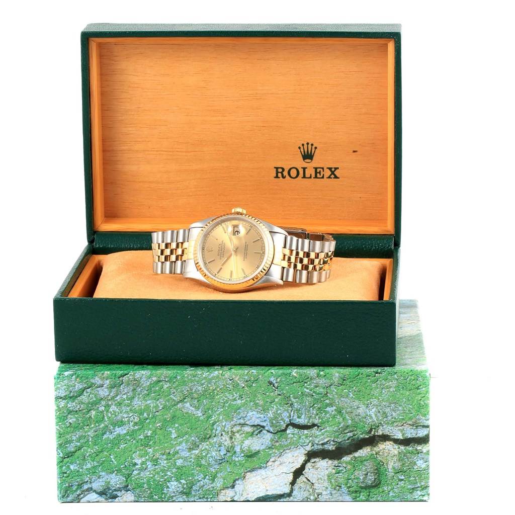 The Rolex Datejust 16233 Steel and Gold (two tone) Champagne Dial 16233 Steel and Gold (two tone) Champagne Dial watch is displayed in an open box, showcasing the face, bracelet, and packaging.