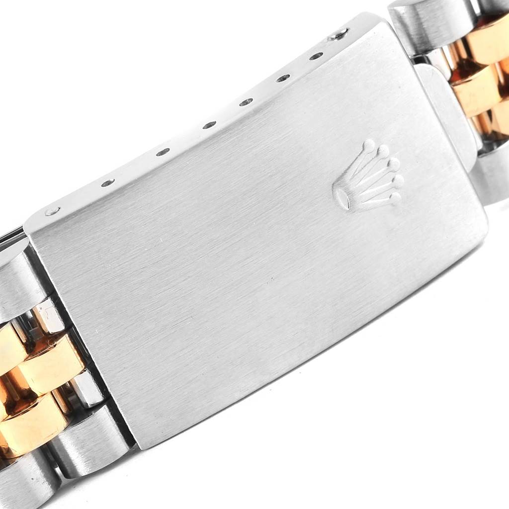 This image shows a close-up of the clasp on a Rolex Datejust 16233 Steel and Gold (two tone) Champagne Dial 16233 Steel and Gold (two tone) Champagne Dial watch bracelet with two-tone metal links.