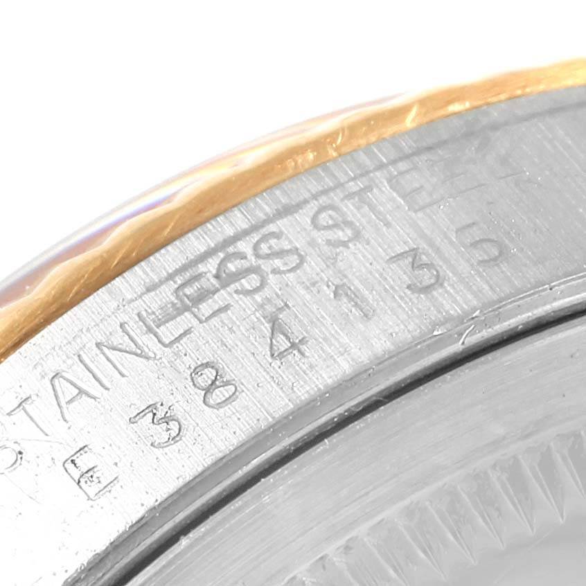 Close-up of a Rolex Datejust 16233 Steel and Gold (two tone) Champagne Dial 16233 Steel and Gold (two tone) Champagne Dial watch showing part of the stainless steel case and engraved serial number.