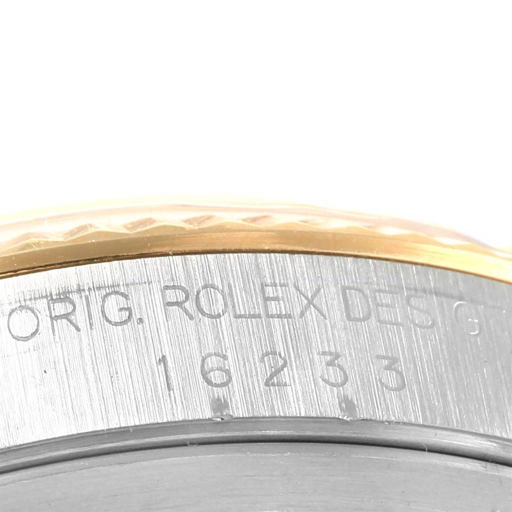 The image shows a macro view of the side of a Rolex Datejust 16233 Steel and Gold (two tone) Blue Dial 16233 Steel and Gold (two tone) Blue Dial watch, focusing on the engraved model number and part of the bezel.