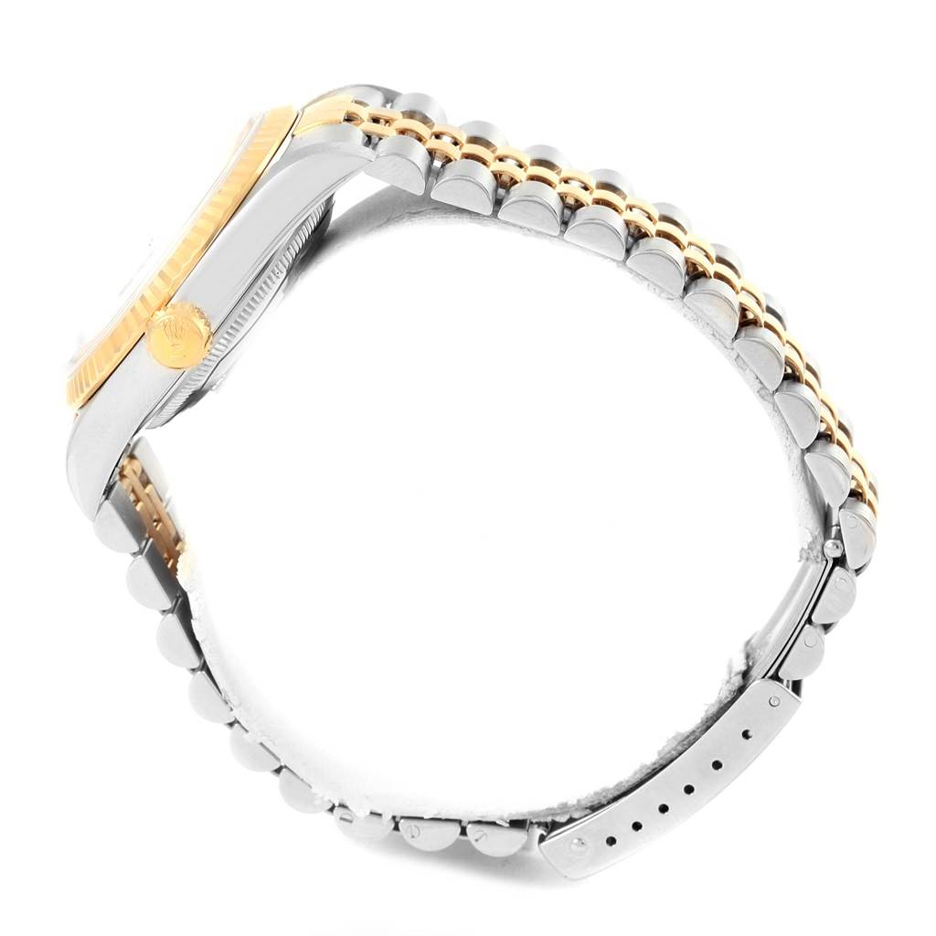 Side view of a Rolex Datejust 16233 Steel and Gold (two tone) Blue Dial 16233 Steel and Gold (two tone) Blue Dial watch showing the crown, case, and two-tone bracelet.