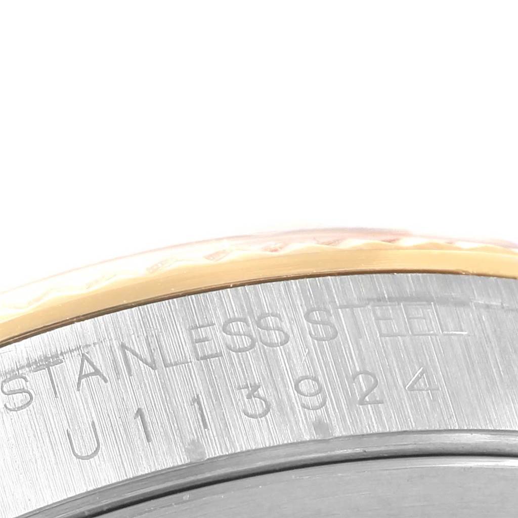 This image shows a close-up of the stainless steel case with engraved serial number of a Rolex Datejust 16233 Steel and Gold (two tone) Blue Dial 16233 Steel and Gold (two tone) Blue Dial watch.