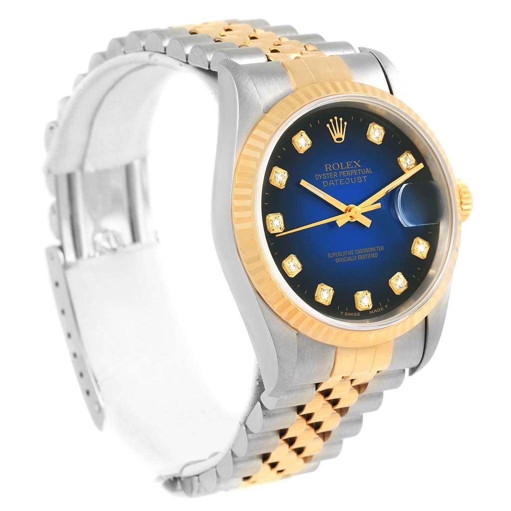 The image shows a side angle of the Rolex Datejust 16233 Steel and Gold (two tone) Blue Dial 16233 Steel and Gold (two tone) Blue Dial watch, highlighting its two-tone band, bezel, and blue dial with diamond hour markers.