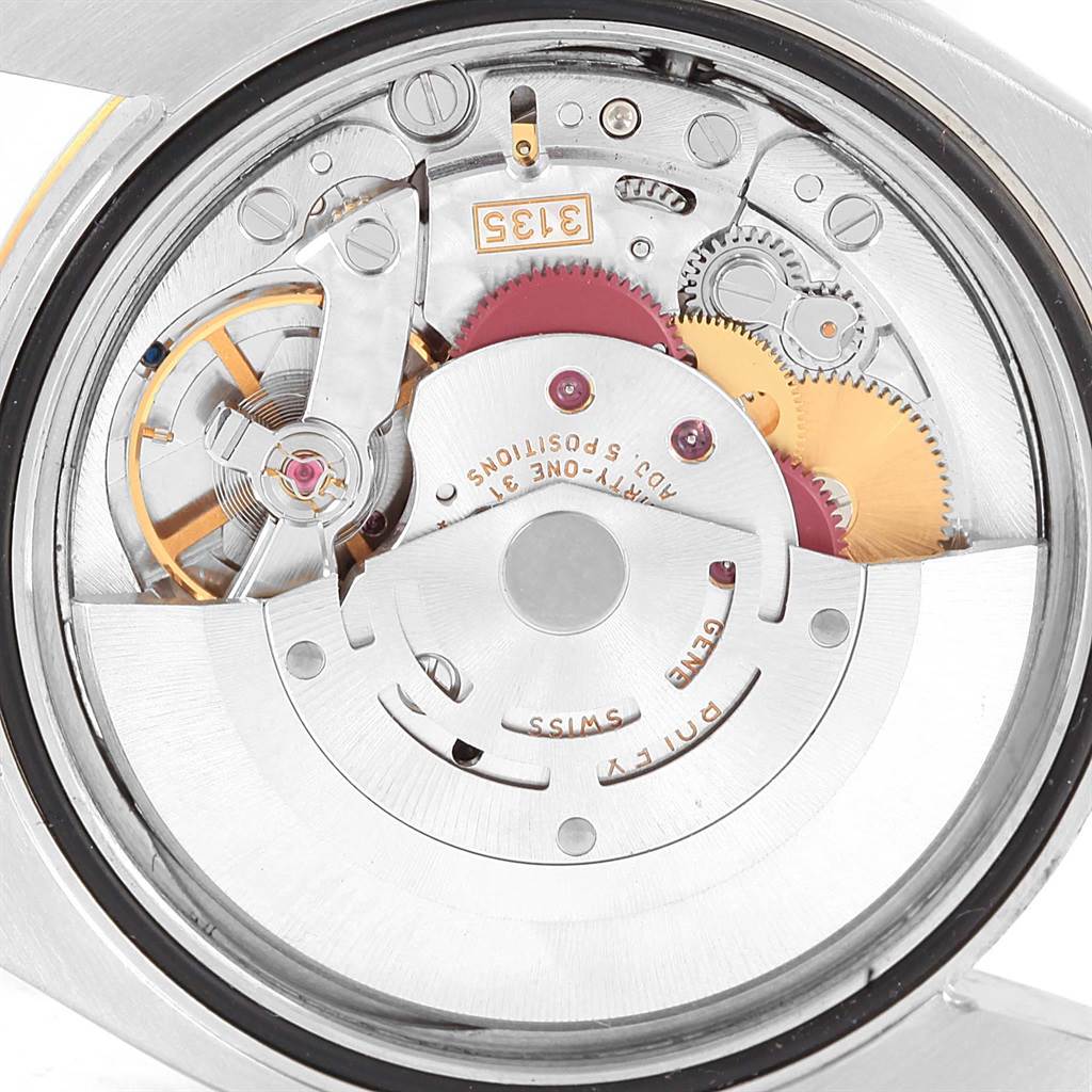 The close-up image shows the movement mechanism of a Rolex Datejust 116233 Men's Stainless Steel Silver Dial 116233 Men's Stainless Steel Silver Dial watch, highlighting gears and other inner components.