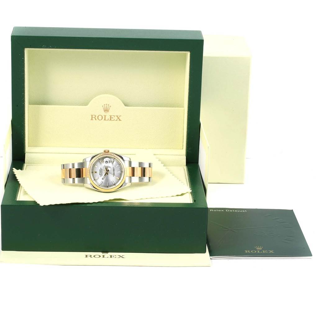 The Rolex Datejust 116233 Men's Stainless Steel Silver Dial 116233 Men's Stainless Steel Silver Dial watch is shown front-on, placed inside an open green and cream box, with accompanying accessories like a booklet.