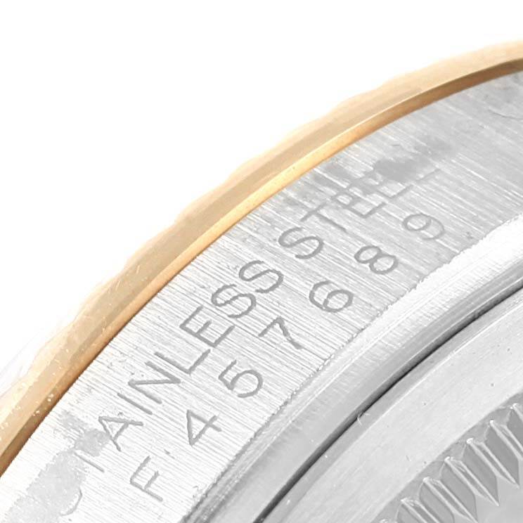 The image shows a close-up of the bezel and part of the engraving on a Rolex Datejust 116233 Men's Stainless Steel Silver Dial 116233 Men's Stainless Steel Silver Dial watch.