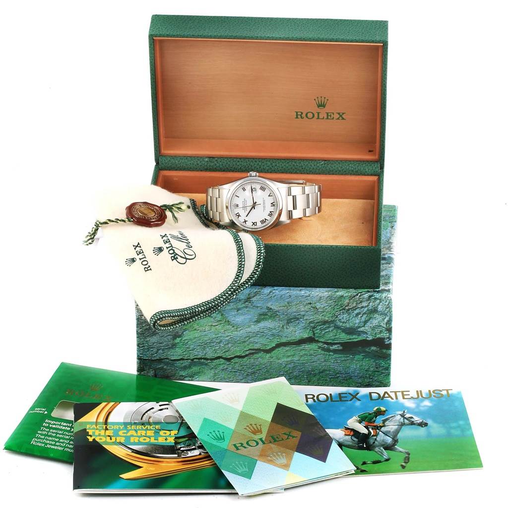 The image shows a Rolex Datejust 16200 Men's Stainless Steel White Dial 16200 Men's Stainless Steel White Dial watch facing forward in an open box with related booklets and accessories.