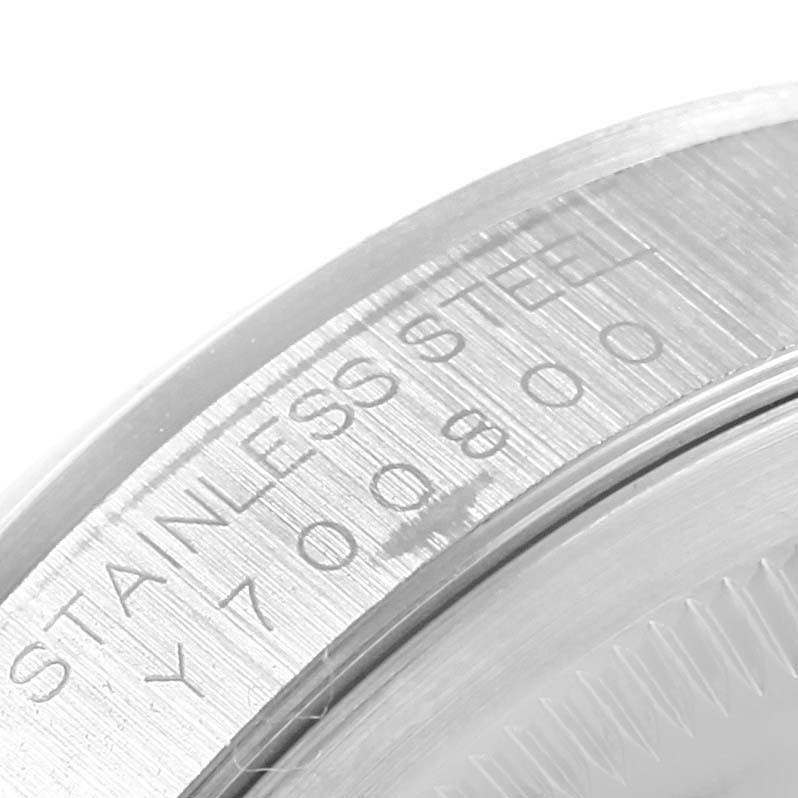 The image shows an angled close-up of the case back engraved with "STAINLESS STEEL" and serial numbers for the Rolex Datejust 16200 Men's Stainless Steel White Dial 16200 Men's Stainless Steel White Dial model.